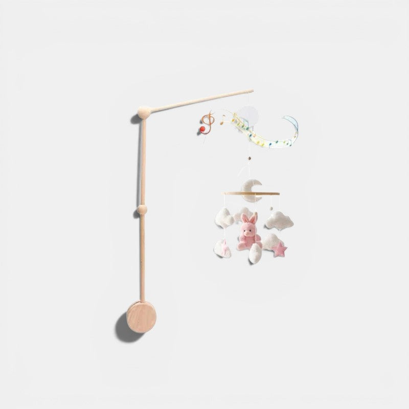 Petit Éveil Montessori arche en bois avec mobile musical, jouets lapin rose, nuages et étoiles.