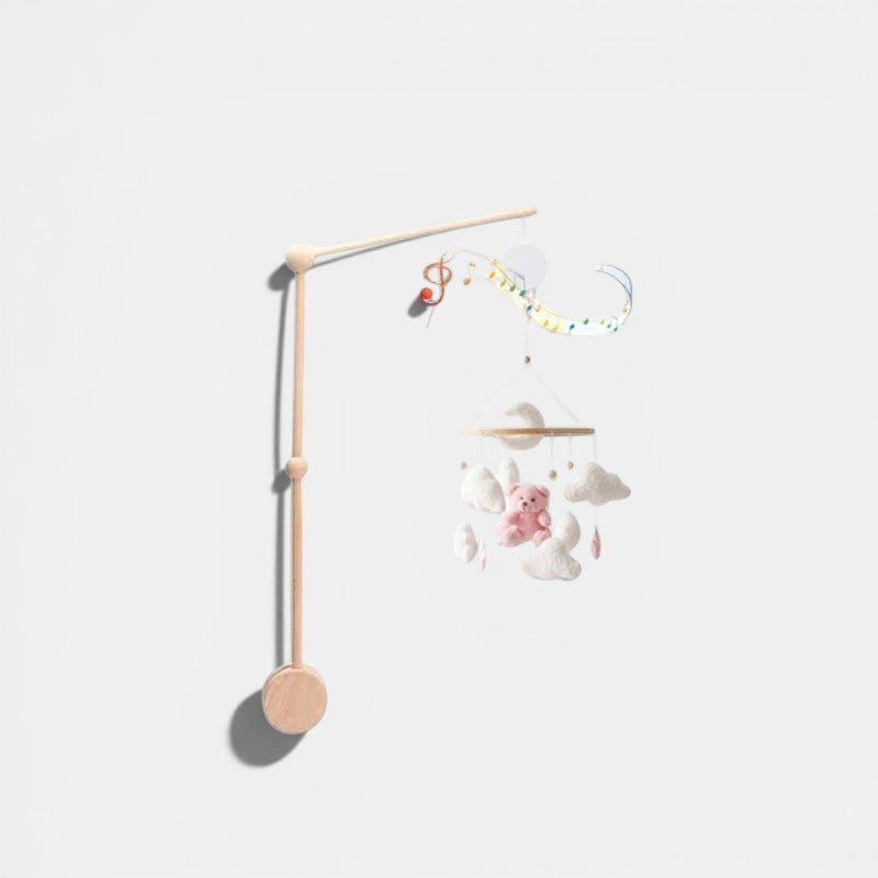 Petit Éveil Montessori : Arche en bois avec mobile musical, ours rose, nuages et notes de musique.