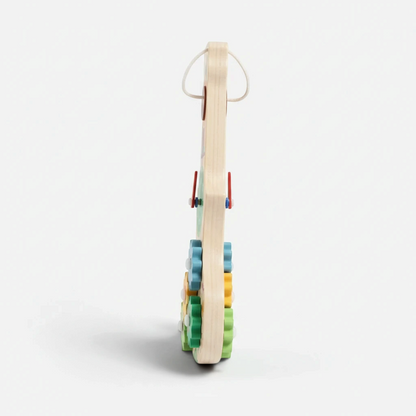 Vue de profil du Busy Board Montessori en bois Petit Éveil Montessori avec ses engrenages colorés et son horloge
