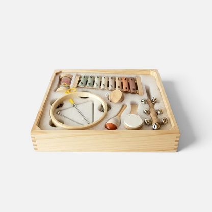 Coffret musical Petit Éveil Montessori en bois avec 8 instruments aux couleurs pastel dans un rangement compartimenté