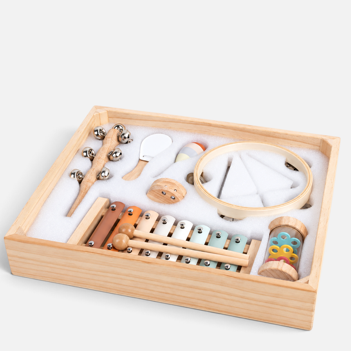 Coffret musical Petit Éveil Montessori en bois avec 8 instruments d'éveil aux couleurs pastel dans leur rangement.
