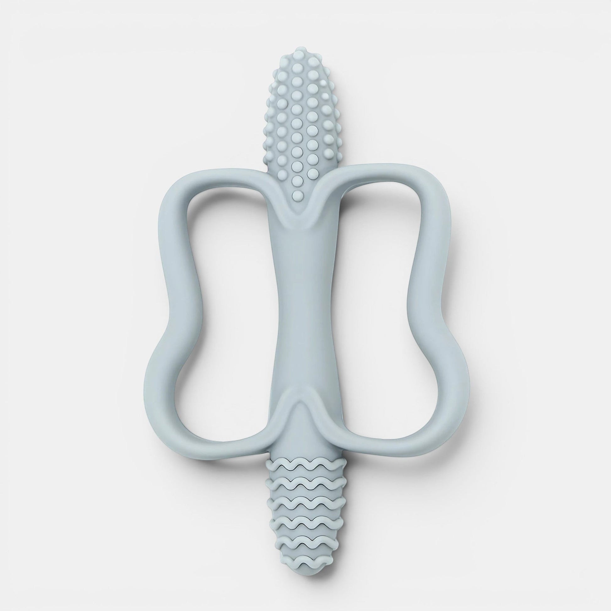 Jouet de dentition Montessori bleu pâle en silicone, forme ergonomique pour bébé, texturé pour soulager les gencives.