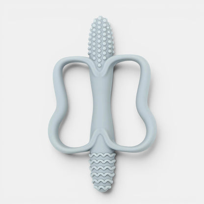 Jouet de dentition Montessori bleu pâle en silicone, forme ergonomique pour bébé, texturé pour soulager les gencives.
