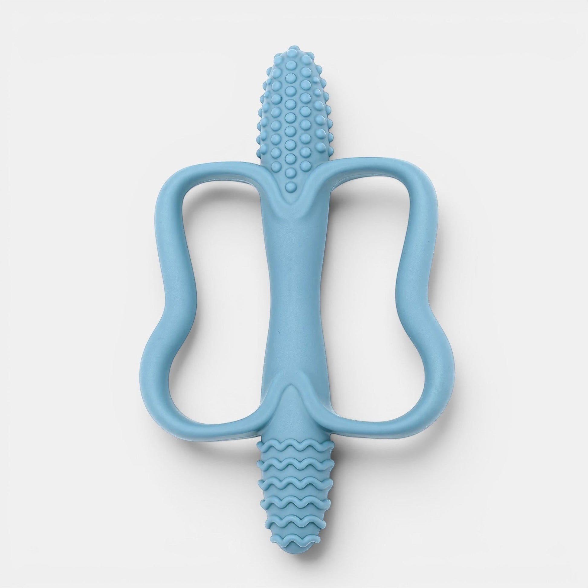Jouet de dentition bleu en silicone, forme de personnage, texturé pour soulager les gencives de bébé. Petit Éveil Montessori.