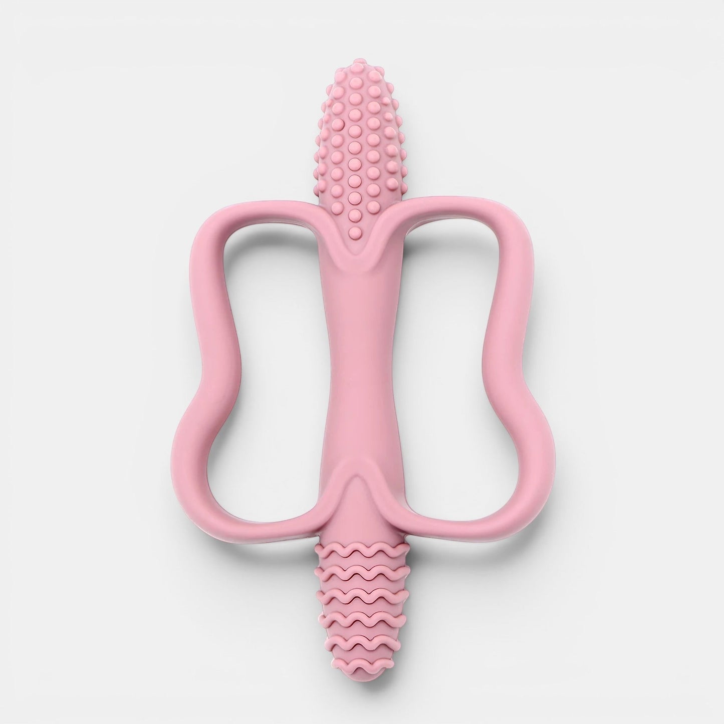 Jouet de dentition rose en silicone Petit Éveil Montessori, texturé pour soulager les gencives de bébé.