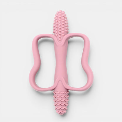 Jouet de dentition rose en silicone Petit Éveil Montessori, texturé pour soulager les gencives de bébé.
