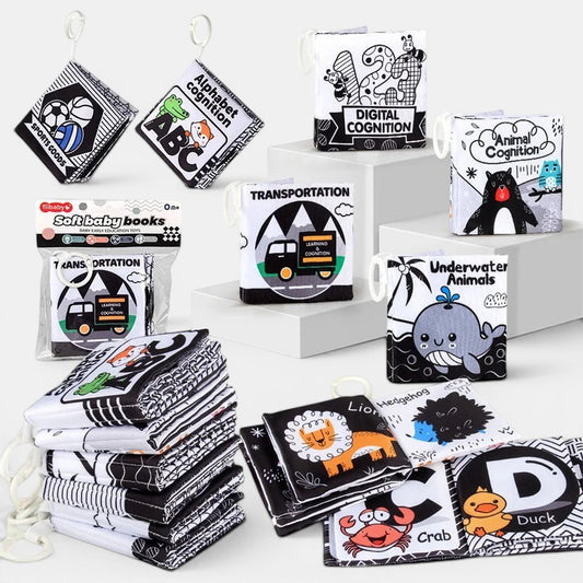 Livre Montessori Petit Éveil Montessori en tissu noir et blanc avec des illustrations d'animaux, chiffres et lettres pour bébé.