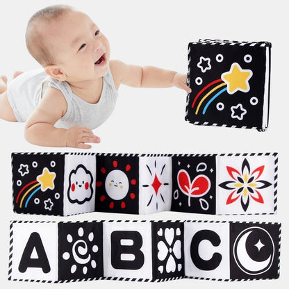 Livre sensoriel en tissu Petit Éveil Montessori noir et blanc avec des étoiles, un arc-en-ciel, des visages, des lettres ABC et des motifs floraux.