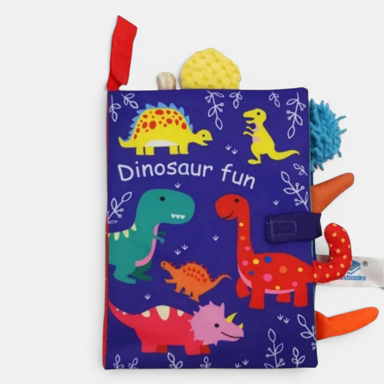 Livre en tissu Petit Éveil Montessori bleu avec des dinosaures colorés et des textures variées pour bébé.